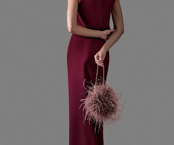 Burgundy evening dress styled with a blush feather bag and chain handle