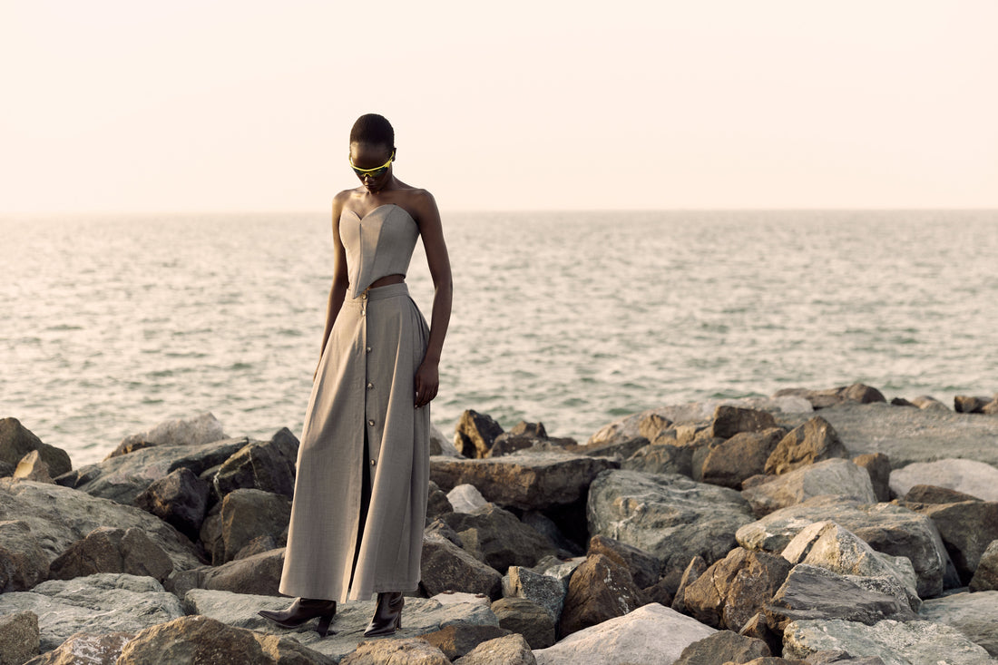 Corset top styled with a long skirt beside the sea