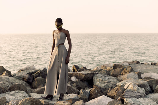 Corset top styled with a long skirt beside the sea