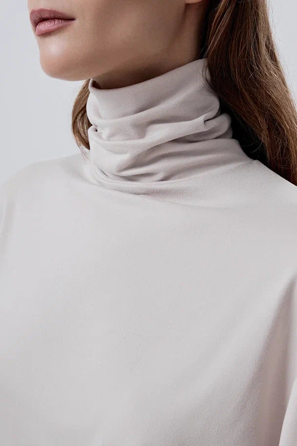 Long-sleeve top with a high neck and a waistband